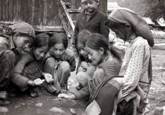 Kids with spinning top. Chitkul, Himalayas.