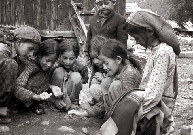 Kids with spinning top. Chitkul, Himalayas.