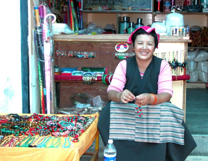 A local Tibetan woman in traditional apron poses for me. Rewalsar, India.
