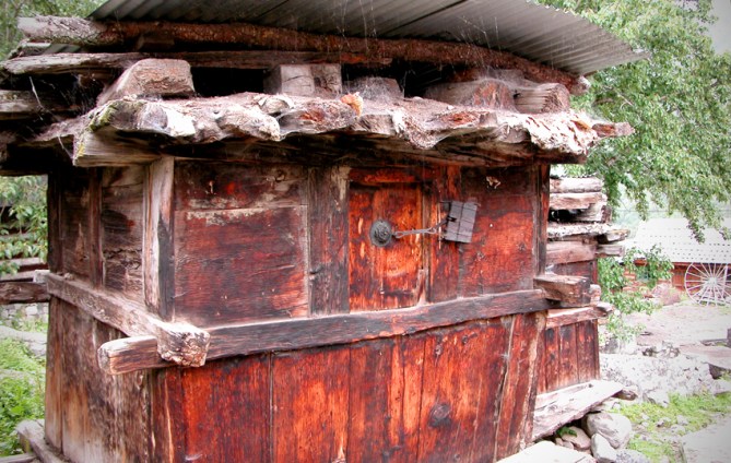 A storehouse with an old padlock on one of its small doors. Each family has a storehouse of their own. Chitkul.