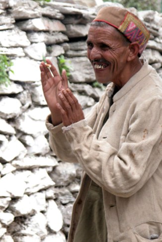 A villager gives thanks for something he just received from a random stranger. Bharmour, Himalayas.