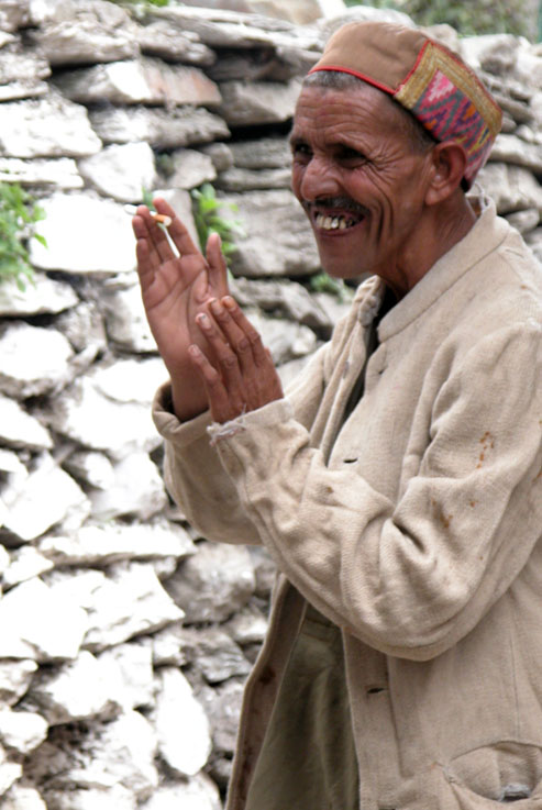 A villager gives thanks for something he just received from a random stranger. Bharmour, Himalayas.